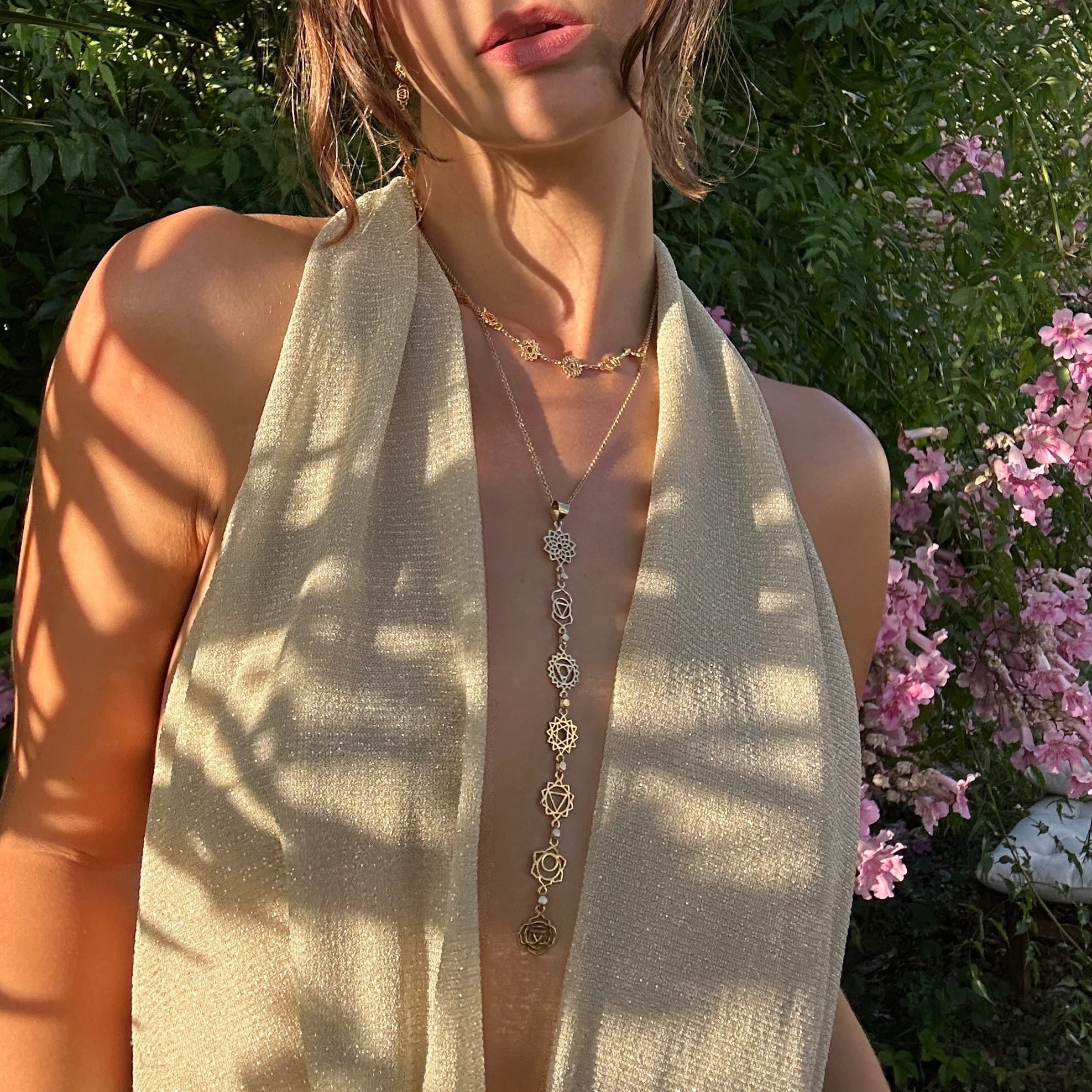 Woman wearing layered handmade Daya spiritual jewelry