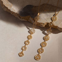 7-Chakra Necklace product flat lay on stone